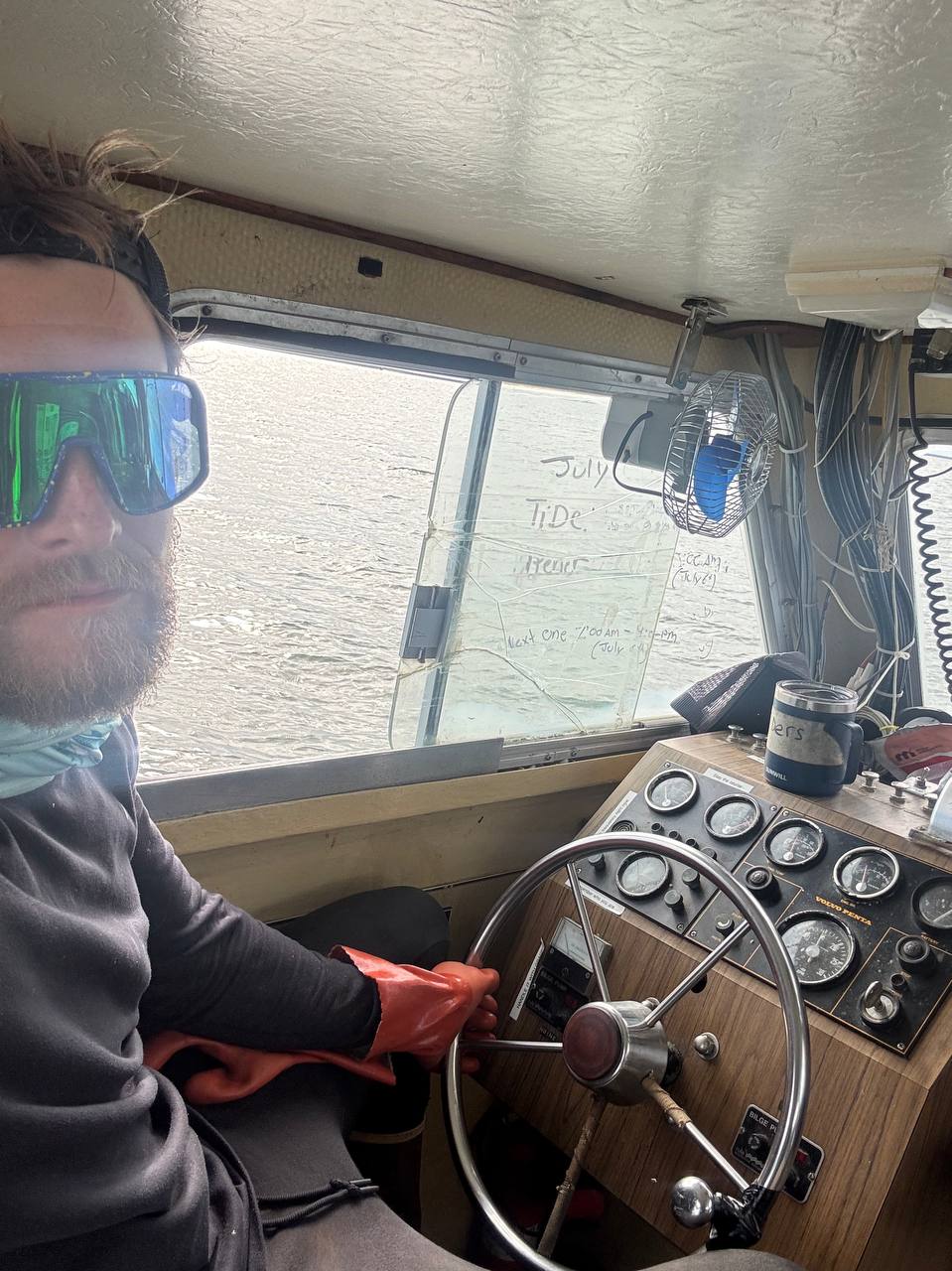At the helm wheelhouse of the F/V Miss Gail with tide notes