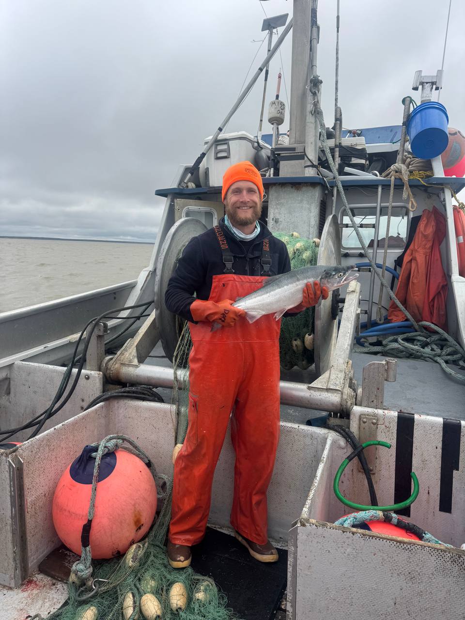 Proudly holding a fresh wild sockeye salmon